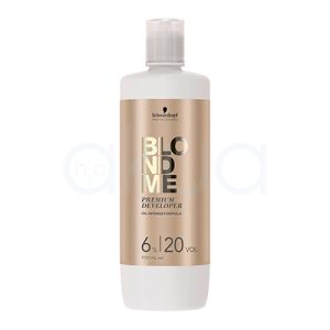 Oxigenada Blondme 20Vol 1000ml envase cilíndrico mayoritariamente blanco, con una etiqueta frontal en color dorado metálico donde se destacan el nombre de la marca y el producto en letras grandes y brillantes H2o Akua