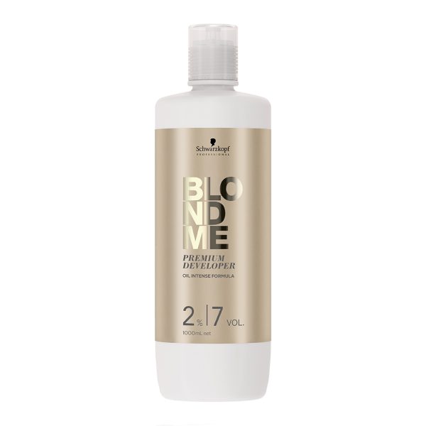Oxigenada Blondme 7Vol 1000ml envase cilíndrico mayoritariamente blanco, con una etiqueta frontal en color dorado metálico donde se destacan el nombre de la marca y el producto en letras grandes y brillantes H2o Akua
