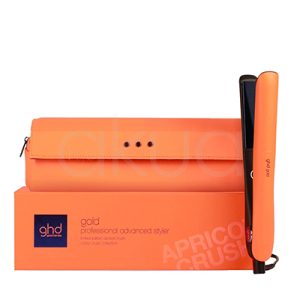 Plancha ghd Gold Naranja de color naranja en la parte exterior de las placas y el cuerpo principal. El interior, incluyendo las placas alisadoras y la base, es de color negro. Además, presenta un botón circular de color azul con el logotipo de la marca en blanco. H2o Akua