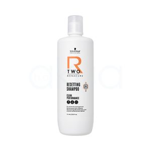 Champu Bonacure R-TWO Restaurador 1000ml El color predominante del envase es blanco. Los textos y elementos gráficos incluyen detalles en negro (para la información), un logotipo en negro y un elemento decorativo llamativo en naranja (letra "R" y algunos detalles geométricos). La tapa del envase también es de color blanco translúcido y mate. H2o Akua