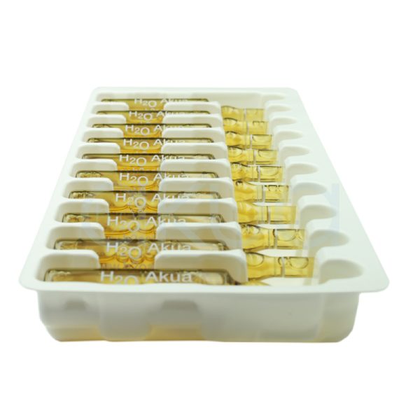 Ampollas anti caida akua 10x30 La imagen presenta una caja principalmente de color blanco con letras grandes en tonos burdeos (granate oscuro) y gris. El texto principal “hair line” aparece en burdeos y gris, mientras que la palabra “akua” está escrita en burdeos en orientación vertical. Las ampollas frontales son de color ámbar translúcido (amarillo dorado), lo que resalta sobre el fondo claro. H2o Akua