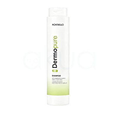 Champu anticaspa dermo pure Montibello 300ml Envase cilíndrico, alto y vertical, de color blanco con detalles en verde y negro en su etiqueta. La parte inferior tiene una franja verde suave y la marca y modelo aparecen impresos de forma vertical en el centro del envase. H2o Akua