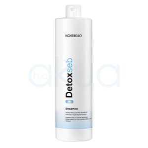 Champu regulador Detox Seb Montibello 1000ml Envase cilíndrico, alargado y vertical, con tapa tipo flip top en la parte superior. El color predominante es blanco, con detalles de texto en negro y azul claro, además de una franja azul en la parte baja del envase. H2o Akua