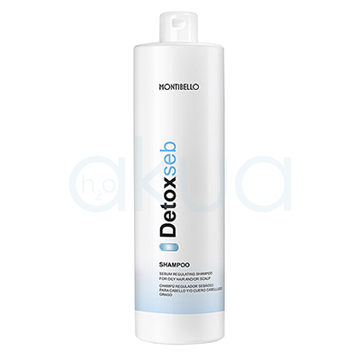 Champu regulador Detox Seb Montibello 1000ml Envase cilíndrico, alargado y vertical, con tapa tipo flip top en la parte superior. El color predominante es blanco, con detalles de texto en negro y azul claro, además de una franja azul en la parte baja del envase. H2o Akua