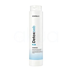 Champu regulador Detox Seb Montibello 300ml. Envase cilíndrico, alargado y vertical, con tapa tipo flip top en la parte superior. El color predominante es blanco, con detalles de texto en negro y azul claro, además de una franja azul en la parte baja del envase. H2o Akua