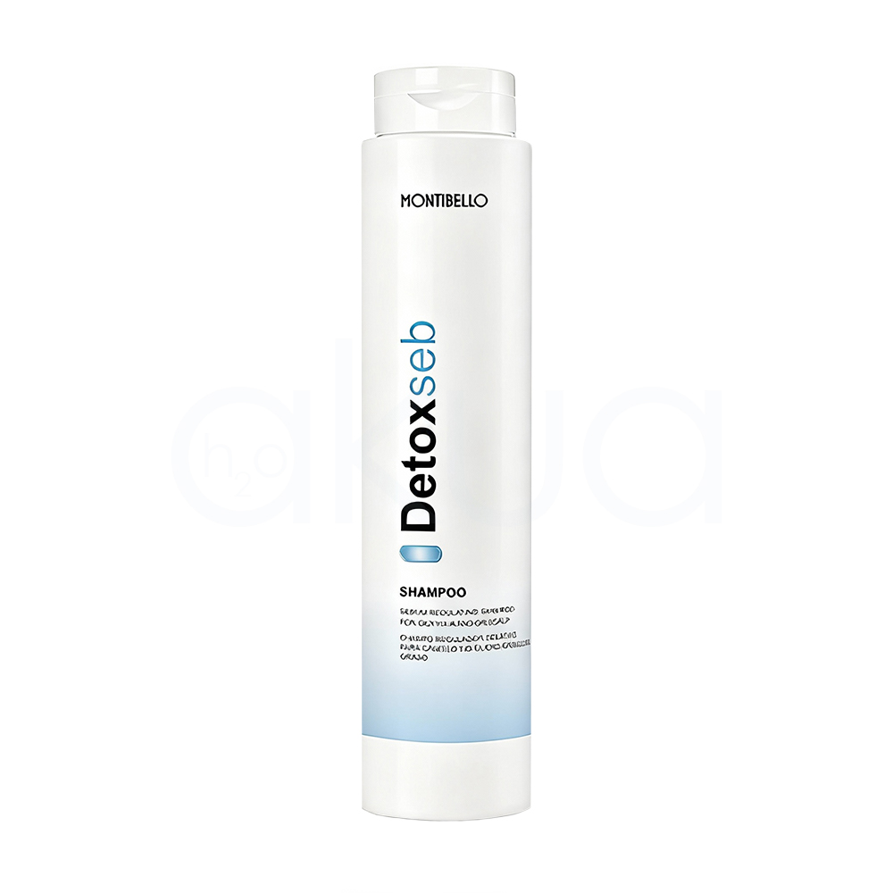 Champu regulador Detox Seb Montibello 300ml. Envase cilíndrico, alargado y vertical, con tapa tipo flip top en la parte superior. El color predominante es blanco, con detalles de texto en negro y azul claro, además de una franja azul en la parte baja del envase. H2o Akua