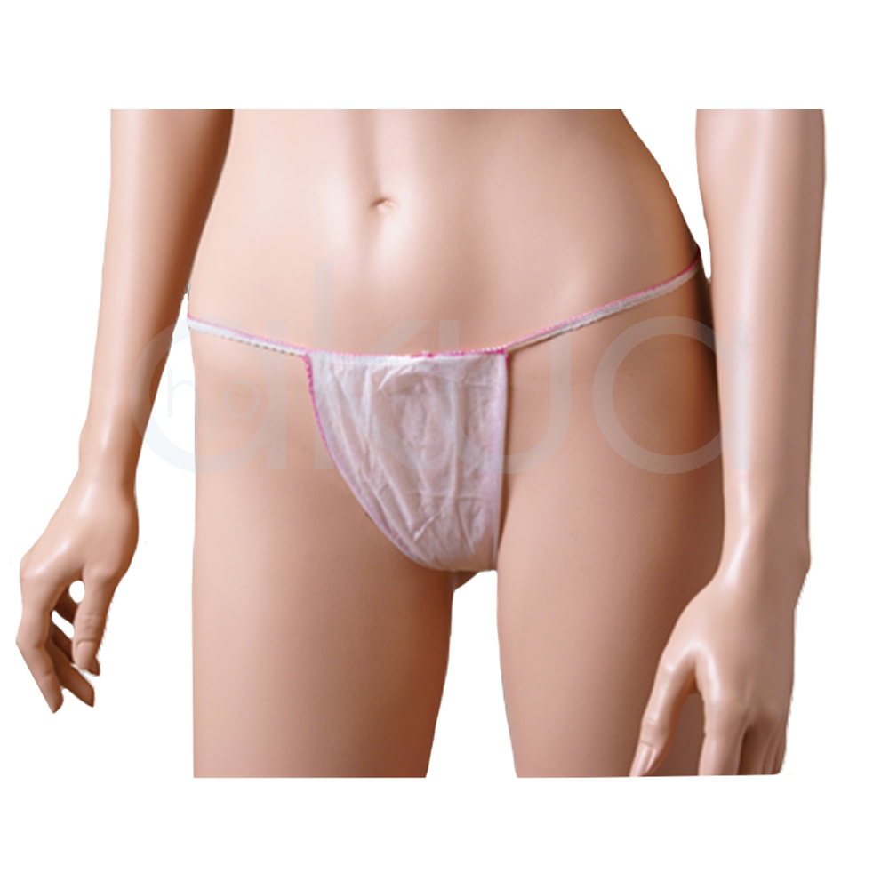 Tanga desechable papel mujer 100unid. Tiene un color blanco translúcido y está confeccionado en material no tejido, ligero y fino. La forma es triangular en la parte frontal, con tiras elásticas finas de color rosa que se ajustan a la cintura, ofreciendo cobertura esencial para zonas íntimas durante tratamientos de estética o depilación.