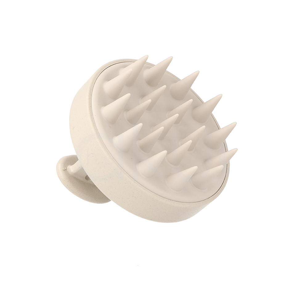 Cepillo masajeador cabello nature oval eco Masajeador capilar manual de color beige claro. Su forma es circular y compacta, con una base plana de la que salen múltiples púas largas y suaves de silicona, diseñadas para masajear el cuero cabelludo. H2o Akua