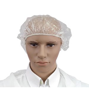 Gorro de belleza desechable TNT plastico 100uni H2o Akua. Gorro desechable de plástico transparente, colocado sobre la cabeza de un maniqui. El gorro cubre completamente el cabello y parte de la frente, ajustándose con una banda elástica para asegurar el cierre alrededor de la cabeza.