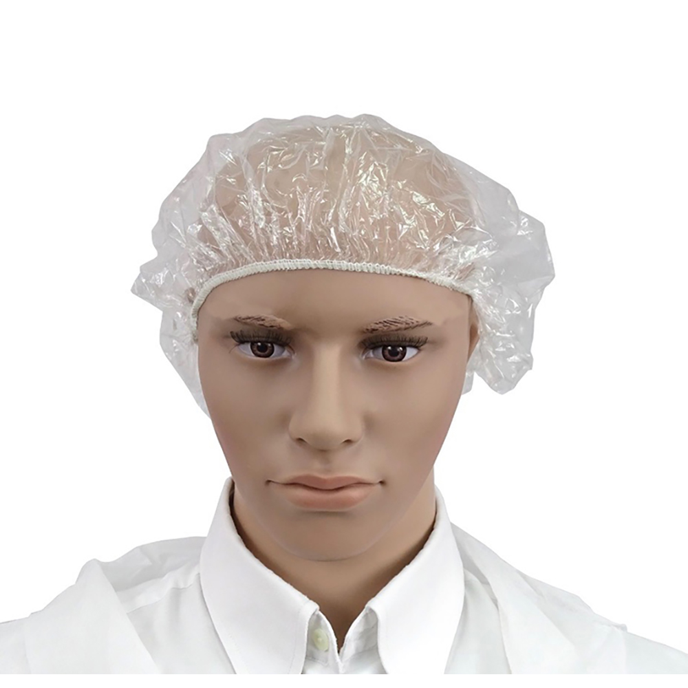 Gorro de belleza desechable TNT plastico 100uni H2o Akua. Gorro desechable de plástico transparente, colocado sobre la cabeza de un maniqui. El gorro cubre completamente el cabello y parte de la frente, ajustándose con una banda elástica para asegurar el cierre alrededor de la cabeza.