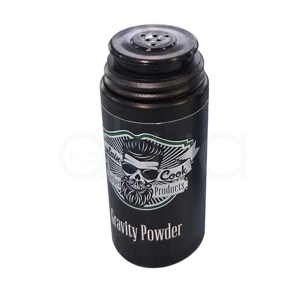 Polvos voluminizadores Captain Cook 30gr. Muestra un envase cilíndrico negro con tapa a rosca y etiqueta de estilo retro-barbería. H2o Akua