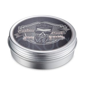 Pomada Rubber Matt Captain Cook 100ml. Envase de plastico de tapa roscada, acabado en plata, que corresponde a la pomada Captain Cook Matt Rubber. En la tapa se aprecia un diseño gráfico con la imagen de un hombre barbudo, gafas y peinado moderno. H2o Akua