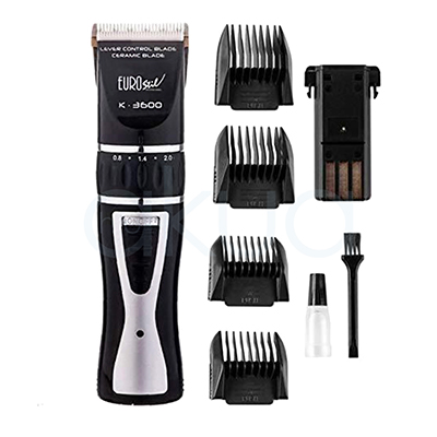 Maquina retoques K-3600 negra Eurostil 03752/50. La imagen muestra una máquina cortapelos profesional , acompañada de sus accesorios y piezas como peines guia de corte, bateria de repuesto, un cepillito en negro y aceite para maquina. La maquina de diseño ergonómico en color negro y blanco, con cuchillas cerámicas. H2o Akua