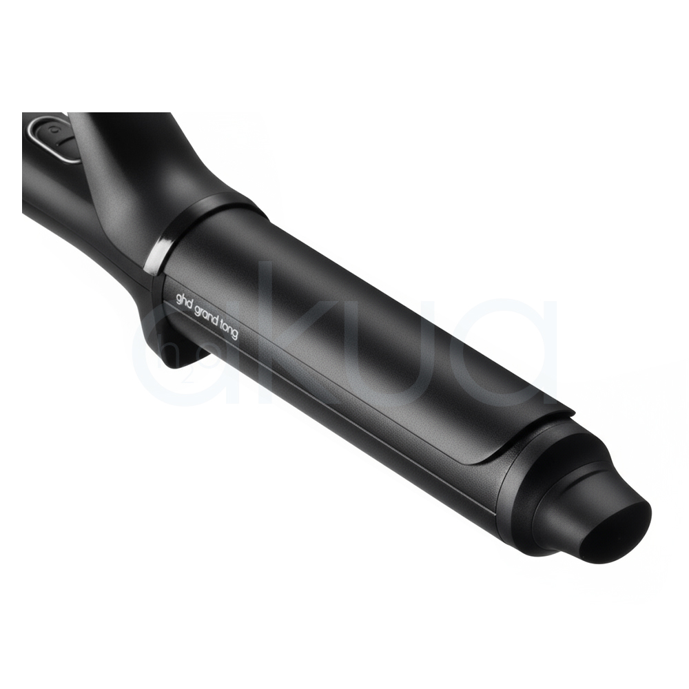 Tenacilla ghd Chonos Curve Grand. La imagen muestra la tenacilla de pelo profesional ghd Chronos Curve Grand junto a su caja de presentación. Ambos elementos están sobre un fondo completamente blanco que resalta el diseño elegante y moderno del producto. La tenacilla es de color negro con detalles metálicos y se distingue por su forma cónica, ideal para crear ondas y rizos definidos en el cabello. La caja negra presenta el nombre del producto y el logotipo de la marca ghd en letras blancas, mostrando una estética minimalista y premium. H2o Akua