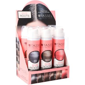 Expositor cubre raices Tassel 07581. La imagen muestra un expositor de salón con varios botes de spray TASSEL BYE ROOTS, un retocador de raíces para el cabello. El display es rosa y en la parte superior aparece una raya en la raíz del pelo indicando antes/después; en la base y los laterales se ven muestras de distintos tonos (negro, castaños, rubios, rojo) correspondientes a los colores disponibles del producto. H2o Akua