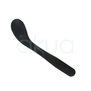Paleta crema H2oAkua. La imagen muestra una espátula facial/mascarilla de color negro liso, sin brillo, sobre fondo blanco. Tiene forma alargada y curvada: un extremo es ovalado y ancho (zona de aplicación) y el otro extremo es recto y más estrecho, actuando como mango ergonómico.