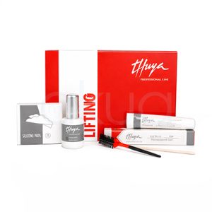 Kit completo Lifting de pestañas Thuya. En primer plano hay una caja roja con la marca y el texto “Lifting”, junto a sus componentes abiertos: dos tubos blancos etiquetados como “Gel Perm” y “Gel Neutralizante”, un tubo plateado de adhesivo, parches de silicona, un cepillo rojo-negro y un pincel fino. Todo está dispuesto de forma ordenada sobre una superficie neutra, destacando el embalaje profesional y los elementos para un tratamiento de curvatura de pestañas. H2o Akua