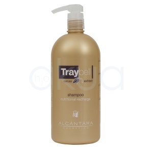 Champu nutritivo cacao Traybell 1000ml Alcantara. El envase tiene forma cilíndrica con bordes redondeados y una base plana. En la parte superior cuenta con un dispensador tipo bomba (pump), lo que facilita su uso. De color dorado/bronce con acabado mate, mientras que el dispensador es blanco. La etiqueta frontal combina tonos oscuros (marrón/negro) con detalles claros. H2o Akua
