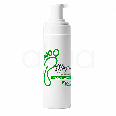 Espuma hidratante Flaky Skin Foot Care Thuya. Envase blanco cilíndrico con dispensador tipo espuma de la marca Thuya Professional Line. El diseño incluye una huella verde grande y texto en negro y verde con el nombre “Foot Care Flaky Skin”. Producto orientado al cuidado de los pies y tratamiento de piel seca o descamada. H2o Akua