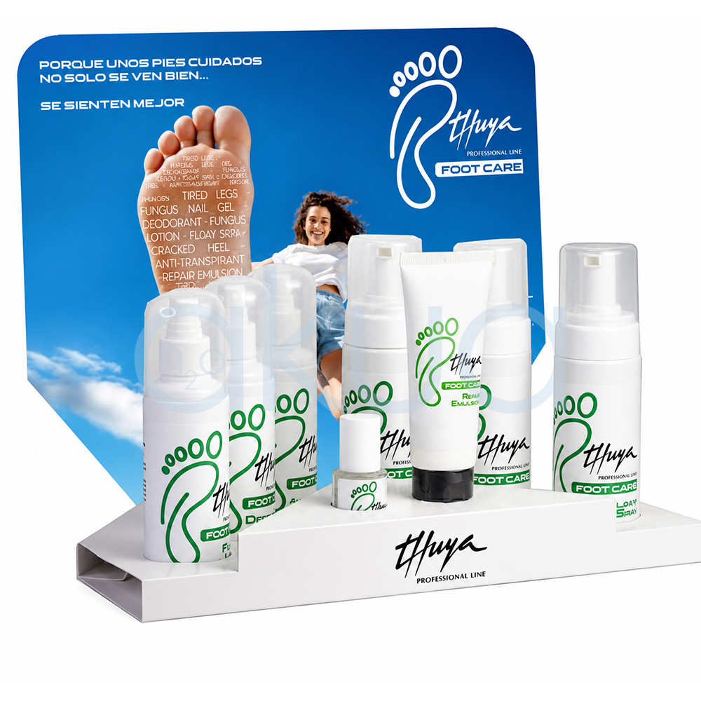 Expositor Foot Care Thuya. Conjunto de productos para el cuidado profesional de los pies de la marca Thuya Foot Care. La imagen muestra varios envases blancos con detalles verdes y negros, incluyendo sprays, espumas, lociones, desodorante, tratamiento antifúngico y una emulsión reparadora en tubo. Los productos están organizados en diferentes alturas y tamaños, con un diseño limpio y profesional típico de catálogo de cosmética y podología. H2o Akua