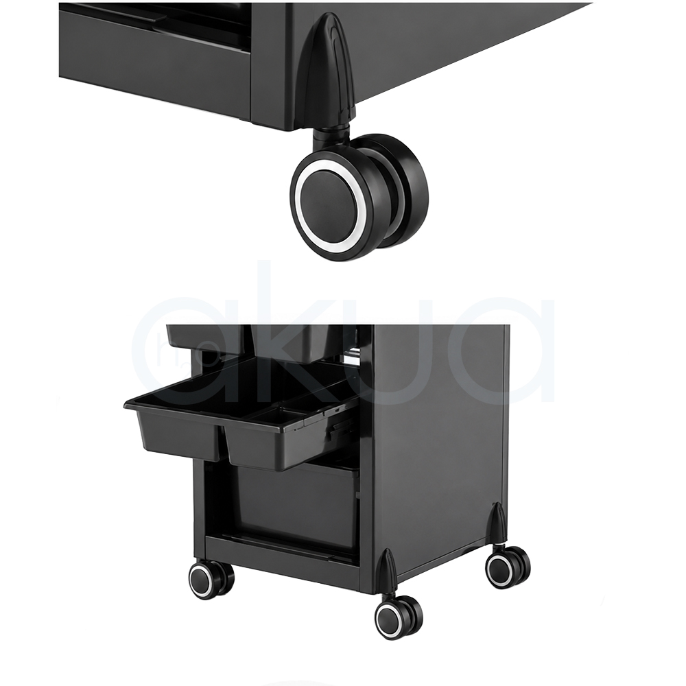 Carrito Rodium H2oAkua. Carro auxiliar profesional de peluquería en color negro con diseño compacto y moderno. Dispone de una bandeja superior para herramientas y productos, varios cajones organizadores de diferentes tamaños en la parte frontal y compartimentos laterales para accesorios de uso frecuente. Incorpora cuatro ruedas giratorias que facilitan su desplazamiento por el salón. Su estructura vertical permite aprovechar el espacio manteniendo ordenados utensilios, productos y herramientas de trabajo