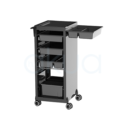 Carrito Rodium H2oAkua. Carro auxiliar profesional de peluquería en color negro con diseño compacto y moderno. Dispone de una bandeja superior para herramientas y productos, varios cajones organizadores de diferentes tamaños en la parte frontal y compartimentos laterales para accesorios de uso frecuente. Incorpora cuatro ruedas giratorias que facilitan su desplazamiento por el salón. Su estructura vertical permite aprovechar el espacio manteniendo ordenados utensilios, productos y herramientas de trabajo