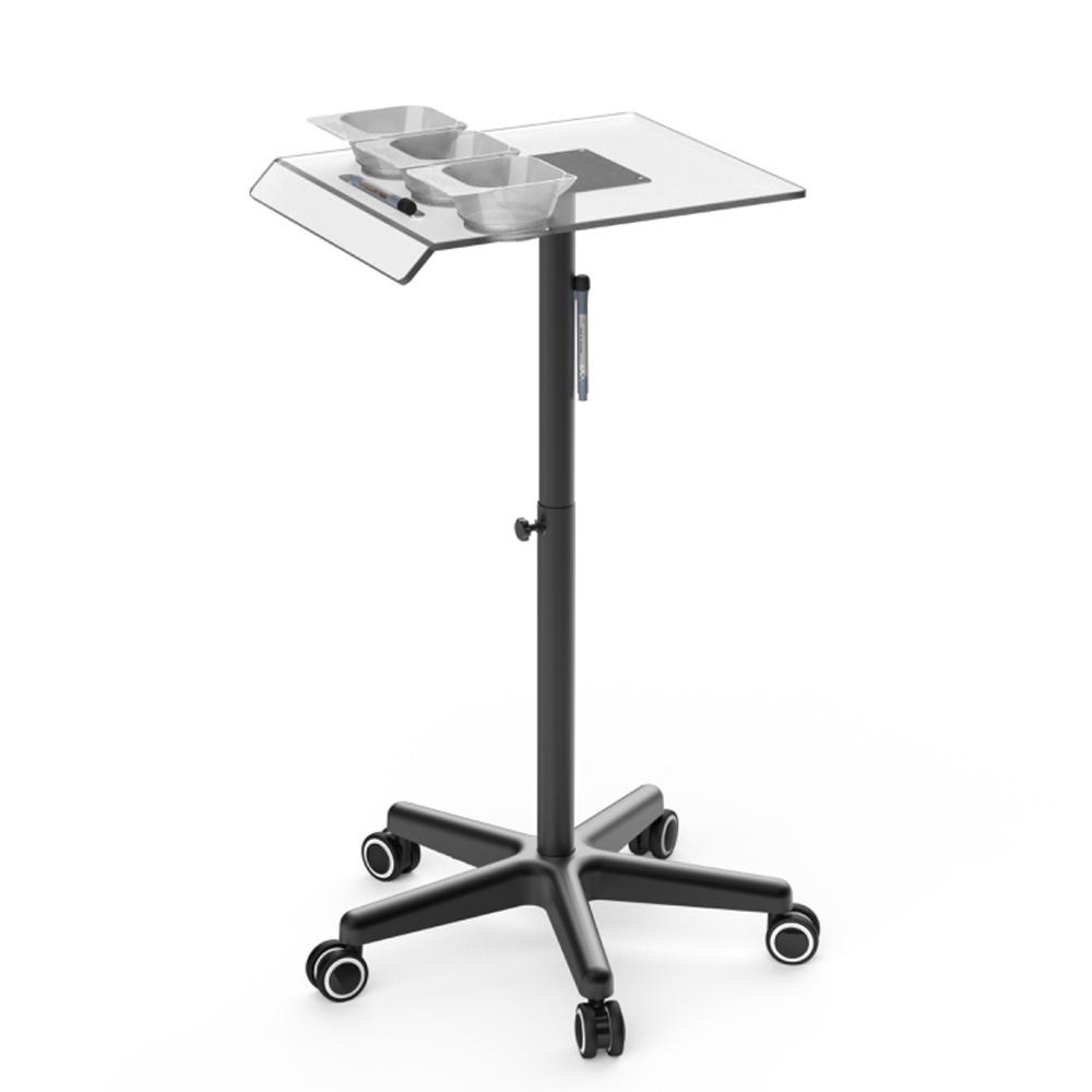 Carrito auxiliar Velura H2oAkua. Carrito auxiliar profesional de peluquería con estructura metálica negra y bandeja superior transparente. La bandeja incorpora tres recipientes para mezcla de tintes o tratamientos capilares, un soporte lateral para documentos o tabletas y un espacio destinado a herramientas de trabajo. Cuenta con columna central regulable en altura mediante pomo de ajuste y una base de cinco brazos con ruedas giratorias que facilitan su movilidad. Su diseño moderno y funcional está pensado para optimizar la organización de productos y accesorios durante servicios de coloración, tratamientos capilares y trabajos técnicos en peluquería.