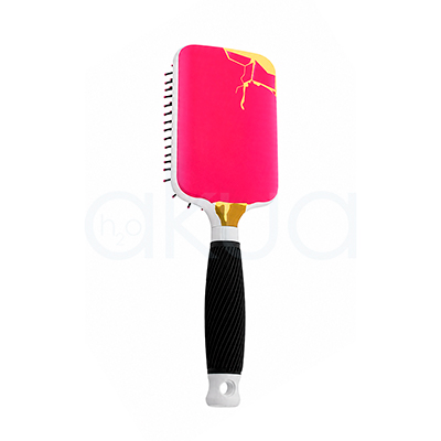 Cepillo desenredante Ice Cream Giubra. Cepillo paddle desenredante con diseño inspirado en un helado. El cabezal rectangular presenta una superficie de color rosa intenso con detalles en tonos amarillo y dorado en la parte superior, simulando un efecto de cobertura derretida. Los laterales son blancos y las púas negras flexibles terminan en pequeñas bolitas rosas para proteger el cuero cabelludo durante el cepillado. El mango combina detalles blancos y dorados en la unión con el cabezal, junto con una empuñadura negra texturizada que facilita el agarre. En el extremo inferior incorpora un orificio para colgarlo. La imagen está realizada sobre un fondo claro que resalta los colores vivos y el diseño llamativo del cepillo. H2o Akua